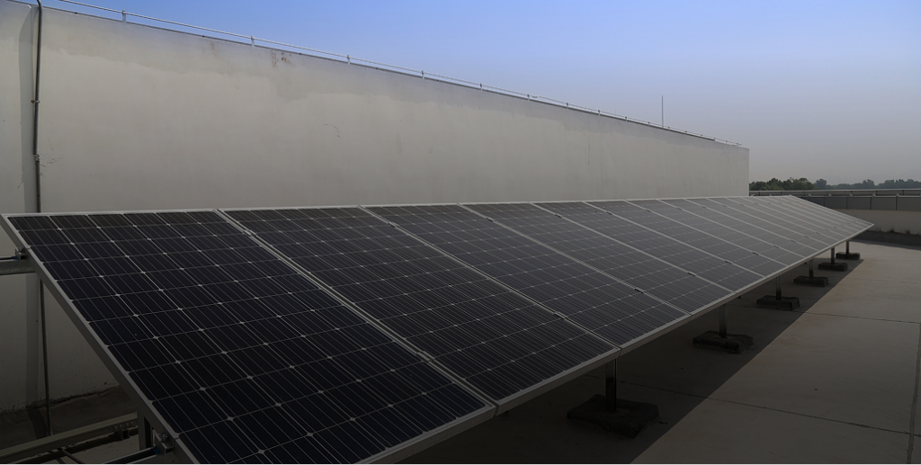 Solar panels on a ground mount racking system, designed for material durability and corrosion resistance.